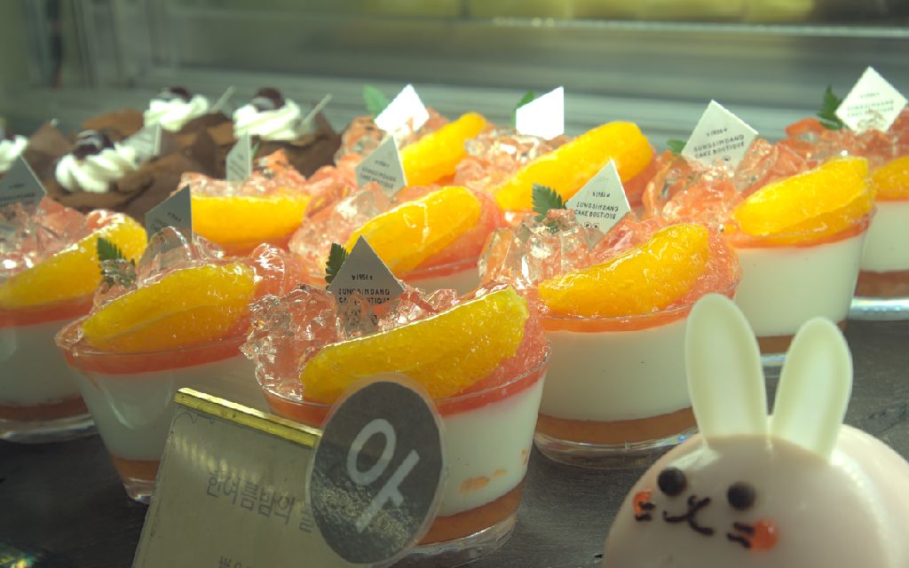 puddings, each covered with shaved ice and an orange slice